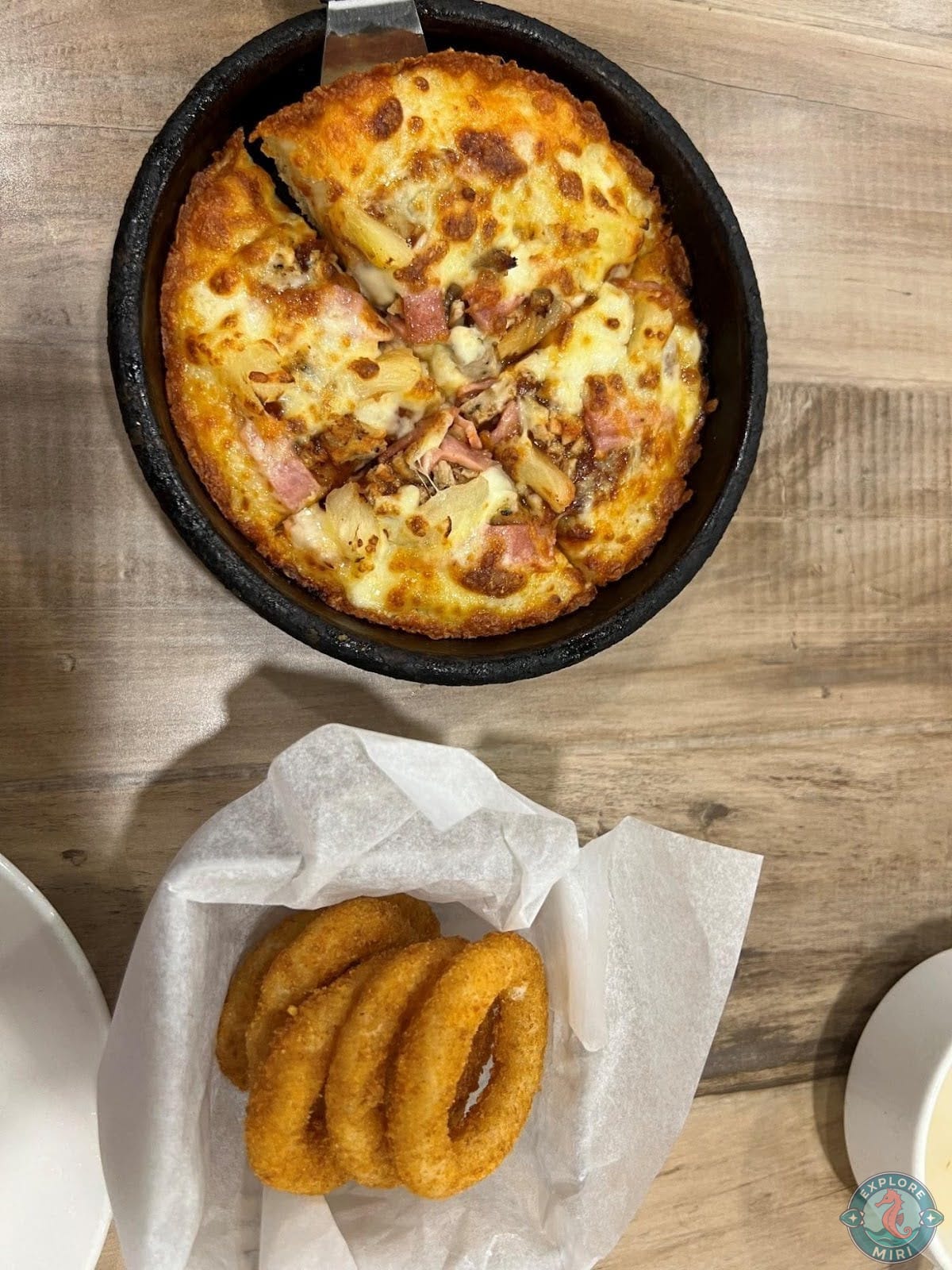 Hawaiian Supreme pizza and a side of crispy onion rings