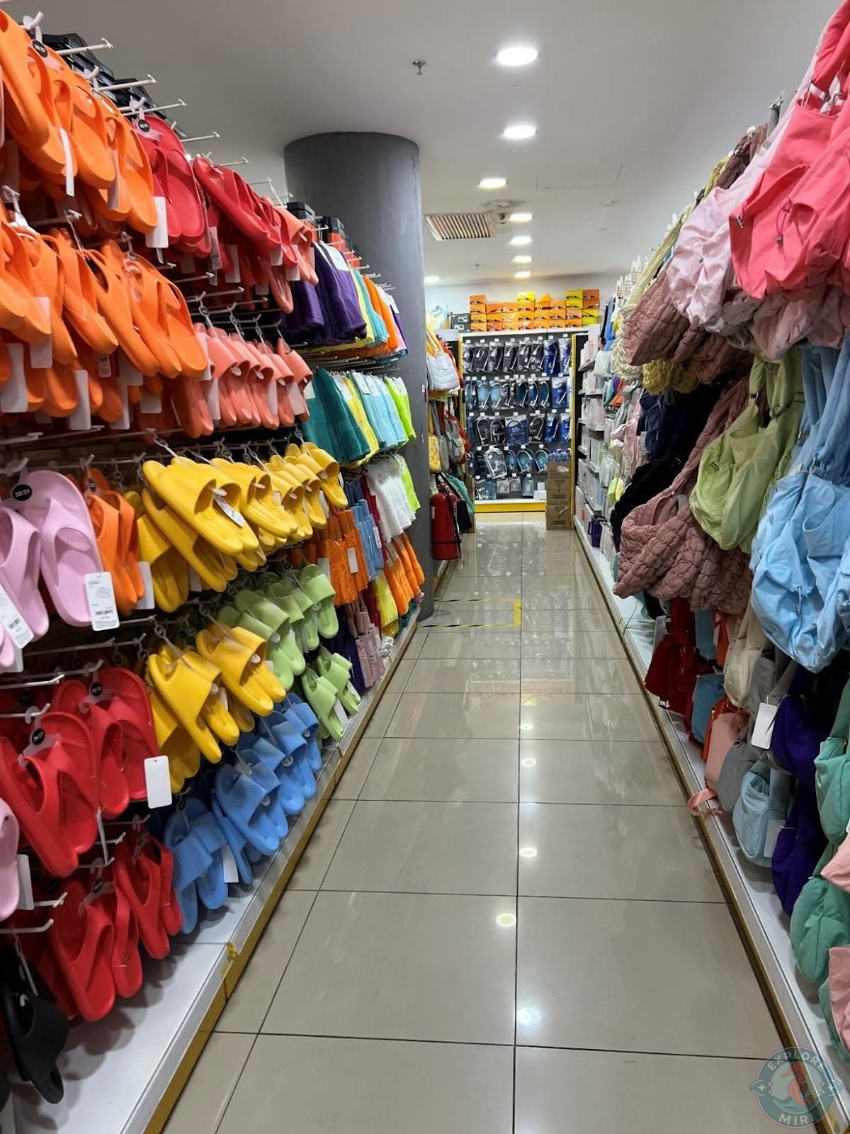 slippers in bright colors of rainbow on one side and handbags of different stitching and sizes on the other side