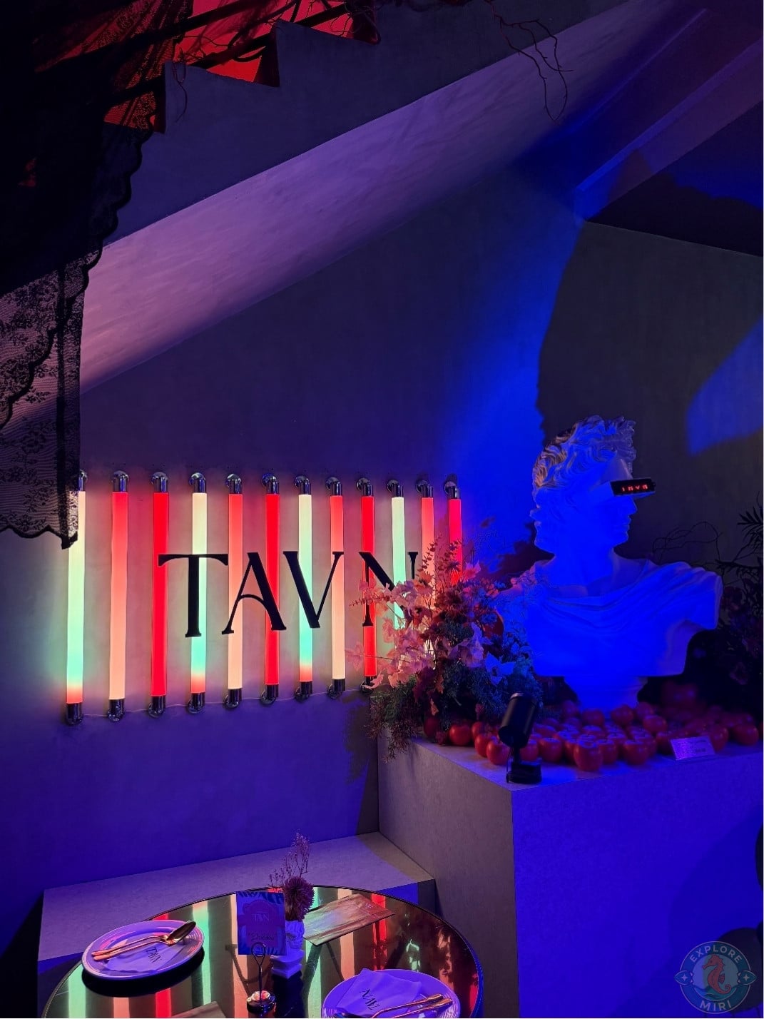 bust beside Tavn sign