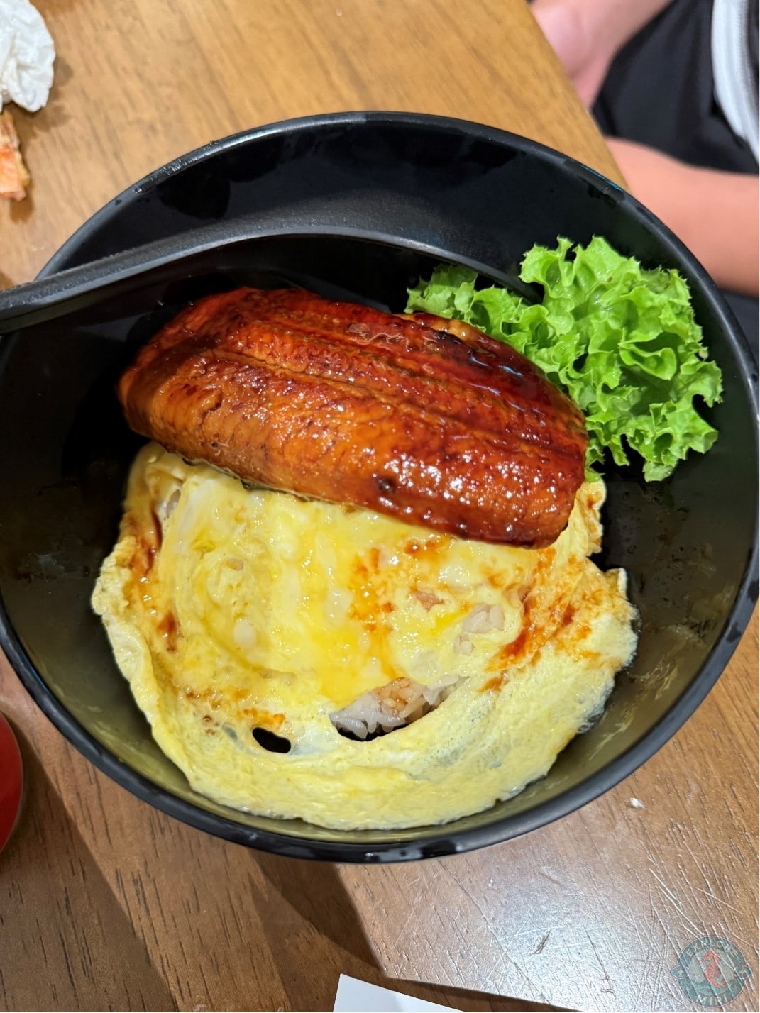 unagi don with unagi fish covered in an Umaria red sauce, soft omelet and a bed of rice