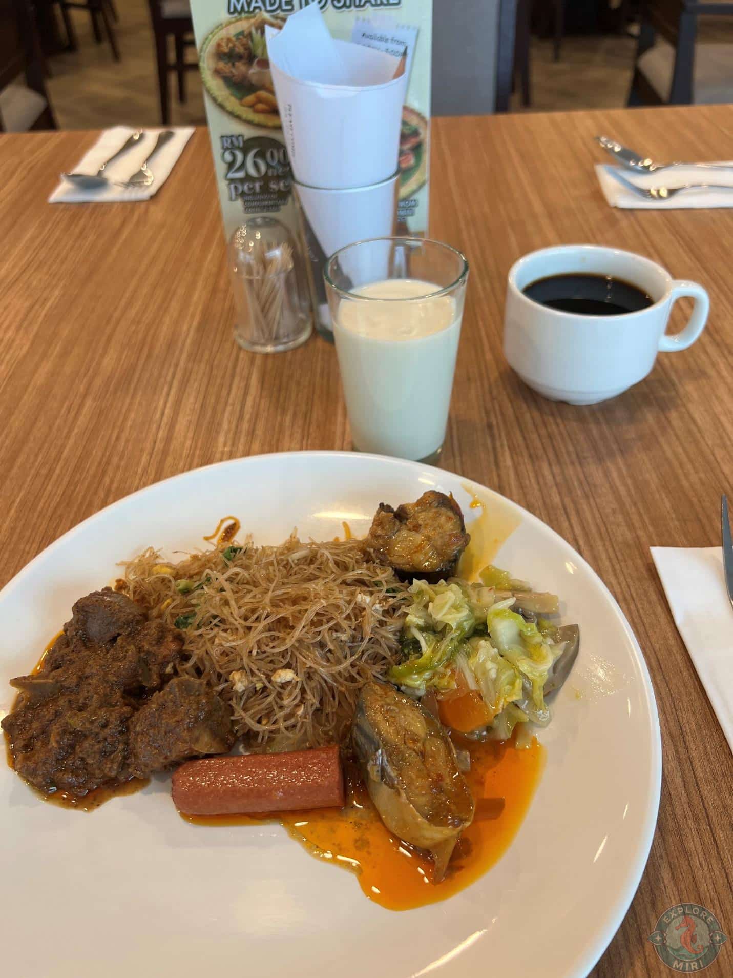 Lamb curry, vermicelli noodles, steamed veggies, fish curry, sausage and some black coffee and milk