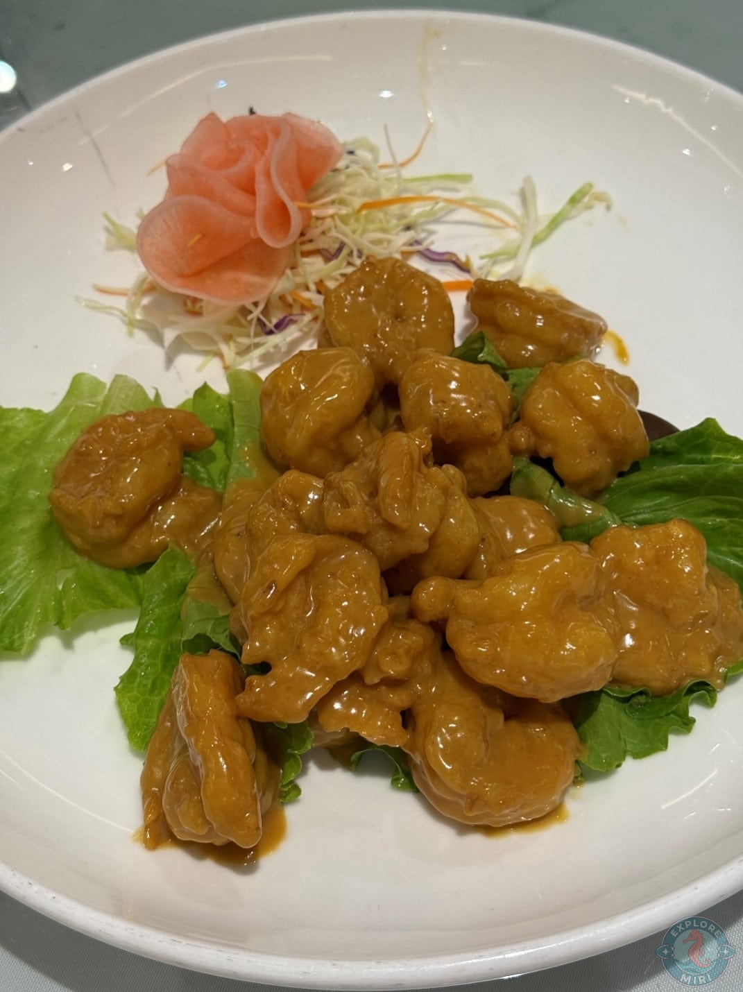 fried prawn balls covered in a creamy butter sauce