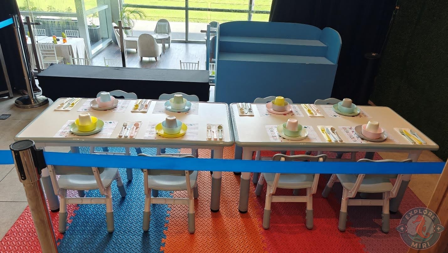 kid’s area with a small table, chairs, plates and glasses