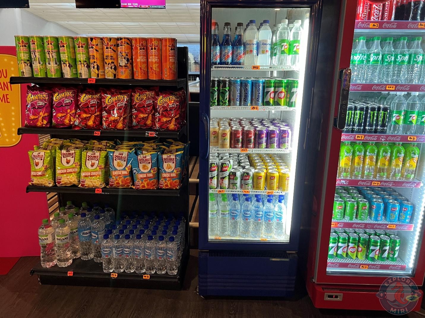 two drinks fridge with sodas and soft drinks along with chips and water stand